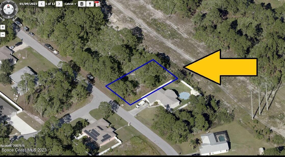 1267 Harlingen Road Southwest Palm Bay, FL 32908 - Photo 2 of 4 an aerial view of a house with a swimming pool
