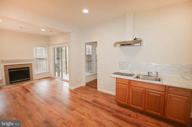 a view of a kitchen with a sink and a stove top oven