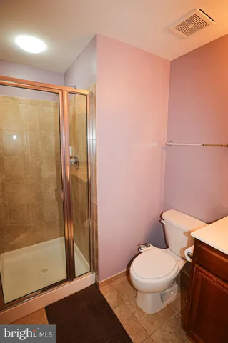 a bathroom with a toilet and a shower