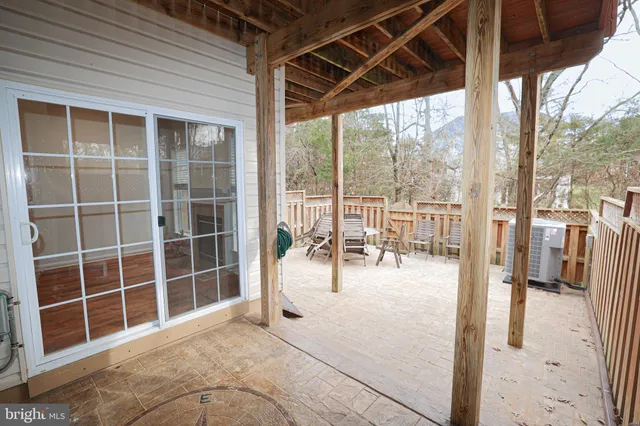 a view of a porch with a table and chairs
