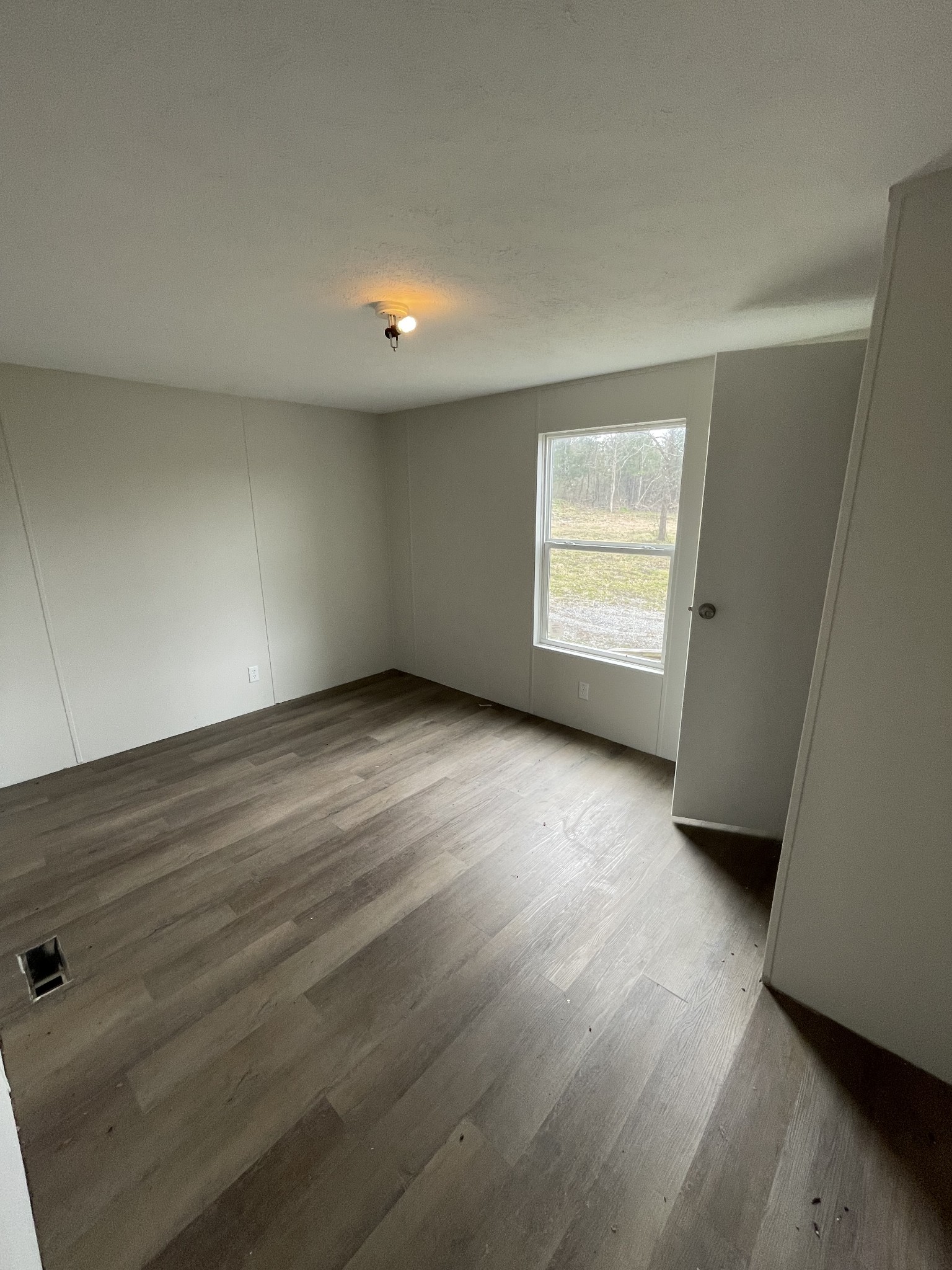 120 March Mill Road Fayetteville, TN 37334 - Photo 10 of 21 an empty room with wooden floor and windows