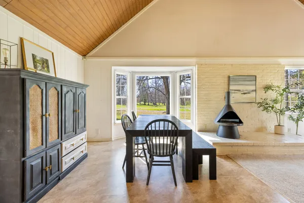 a kitchen with stainless steel appliances kitchen island granite countertop a refrigerator and a stove top oven