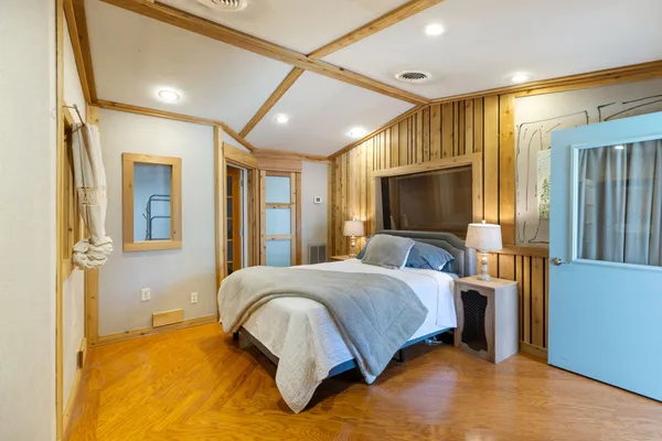 a bedroom with a large bed and a lamp
