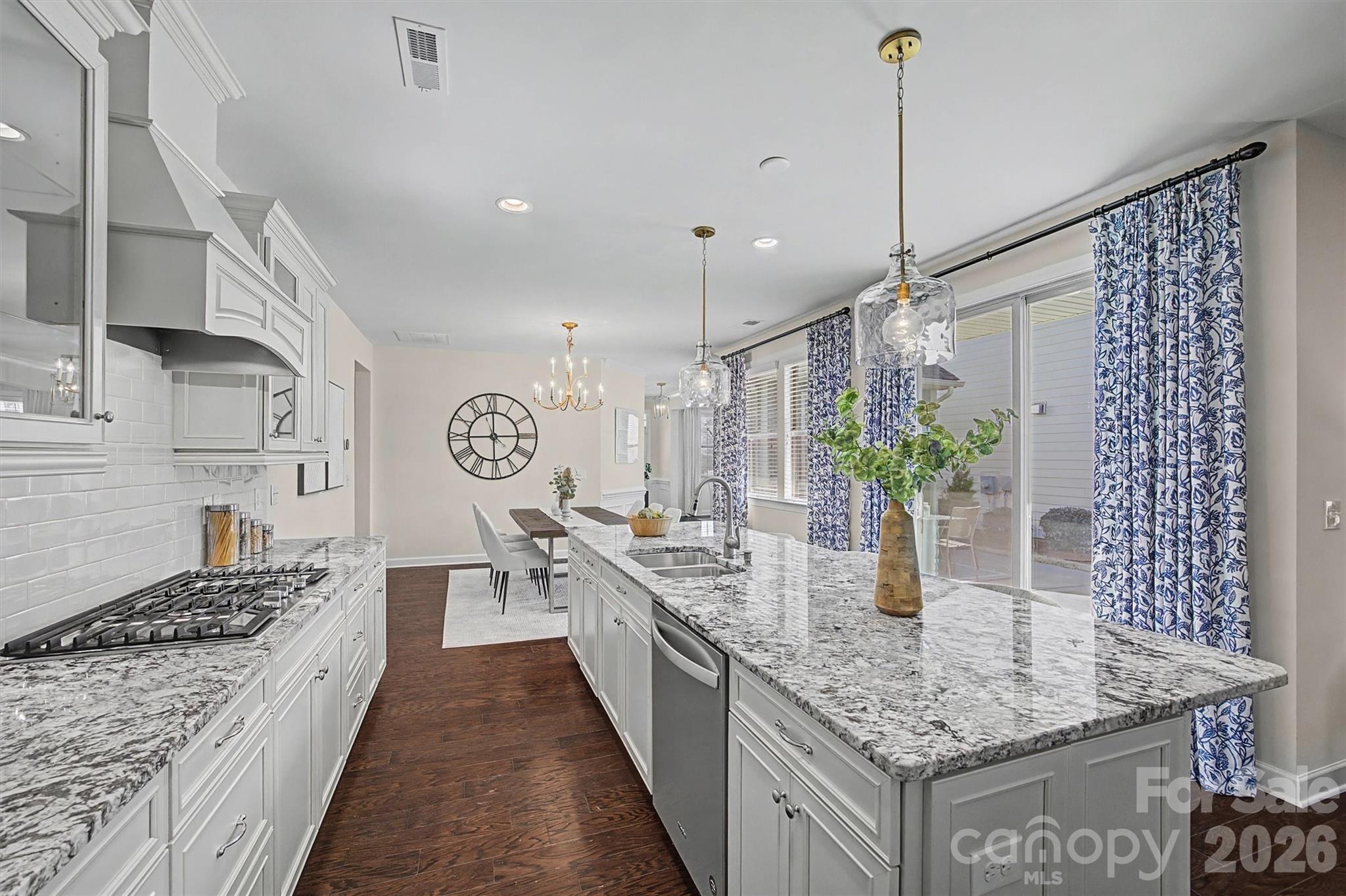 1268 Independence Street Tega Cay, SC 29708 - Photo 11 of 38 a large kitchen with kitchen island a large counter top space a sink stainless steel appliances and cabinets