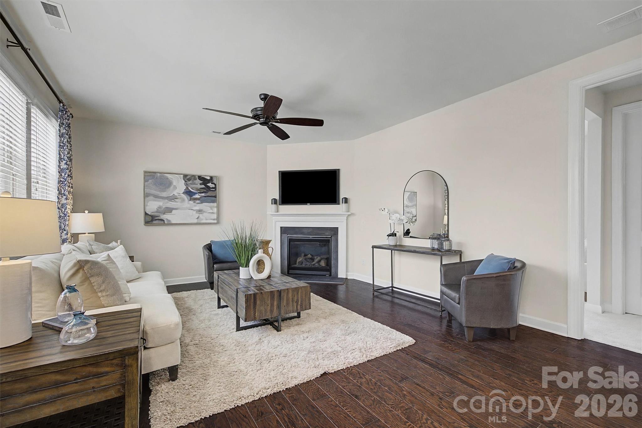 1268 Independence Street Tega Cay, SC 29708 - Photo 12 of 38 a living room with furniture a fireplace and a flat screen tv