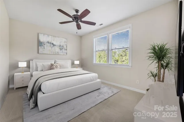 a spacious bedroom with a bed and a window