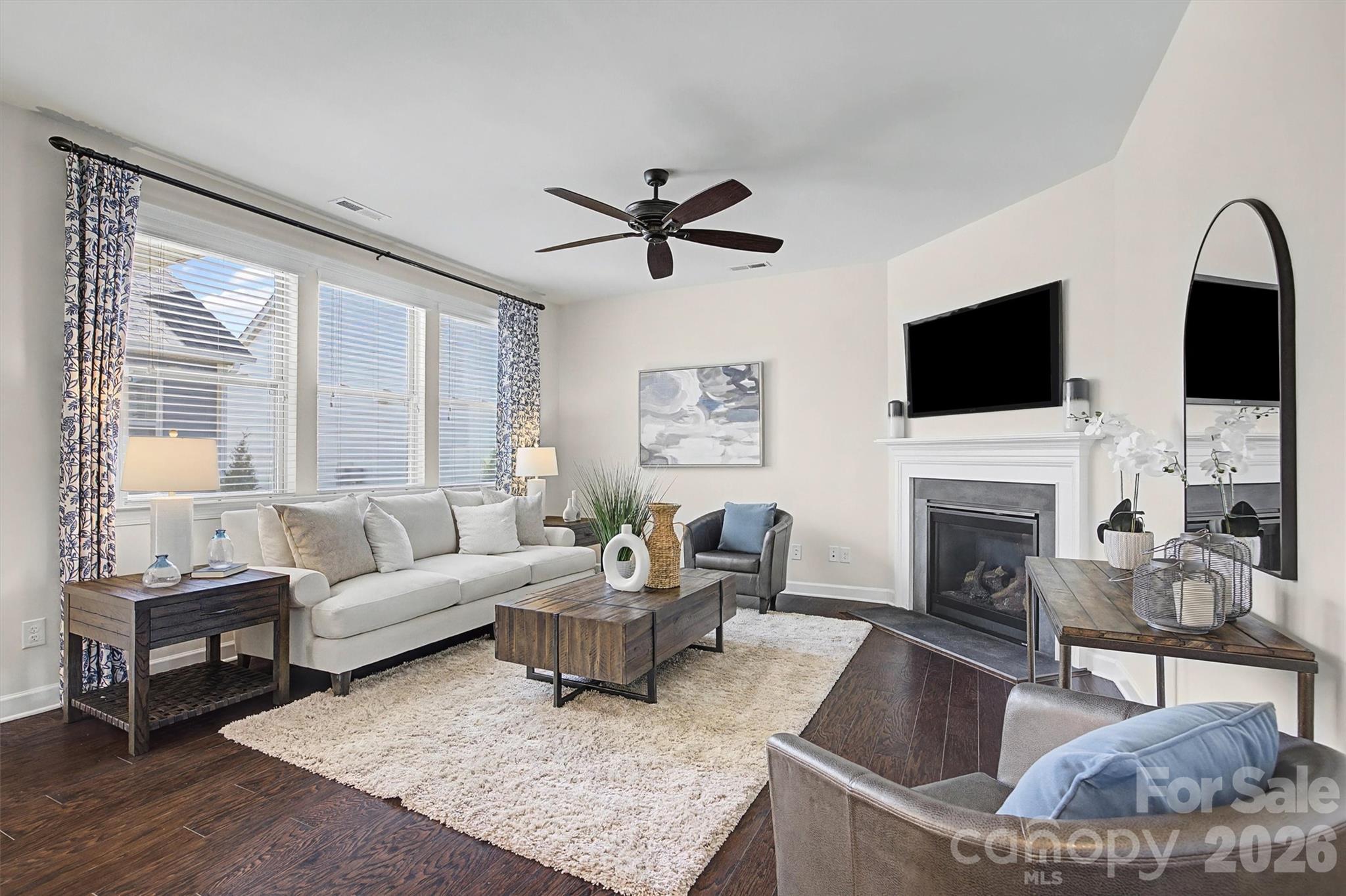 1268 Independence Street Tega Cay, SC 29708 - Photo 13 of 38 a living room with furniture a fireplace and a flat screen tv