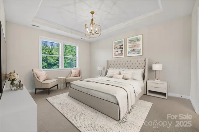 a spacious bedroom with a bed and a chandelier