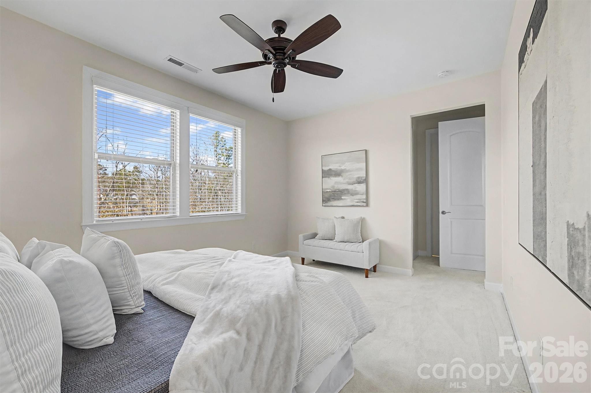 1268 Independence Street Tega Cay, SC 29708 - Photo 15 of 38 a bedroom with a bed and a large window