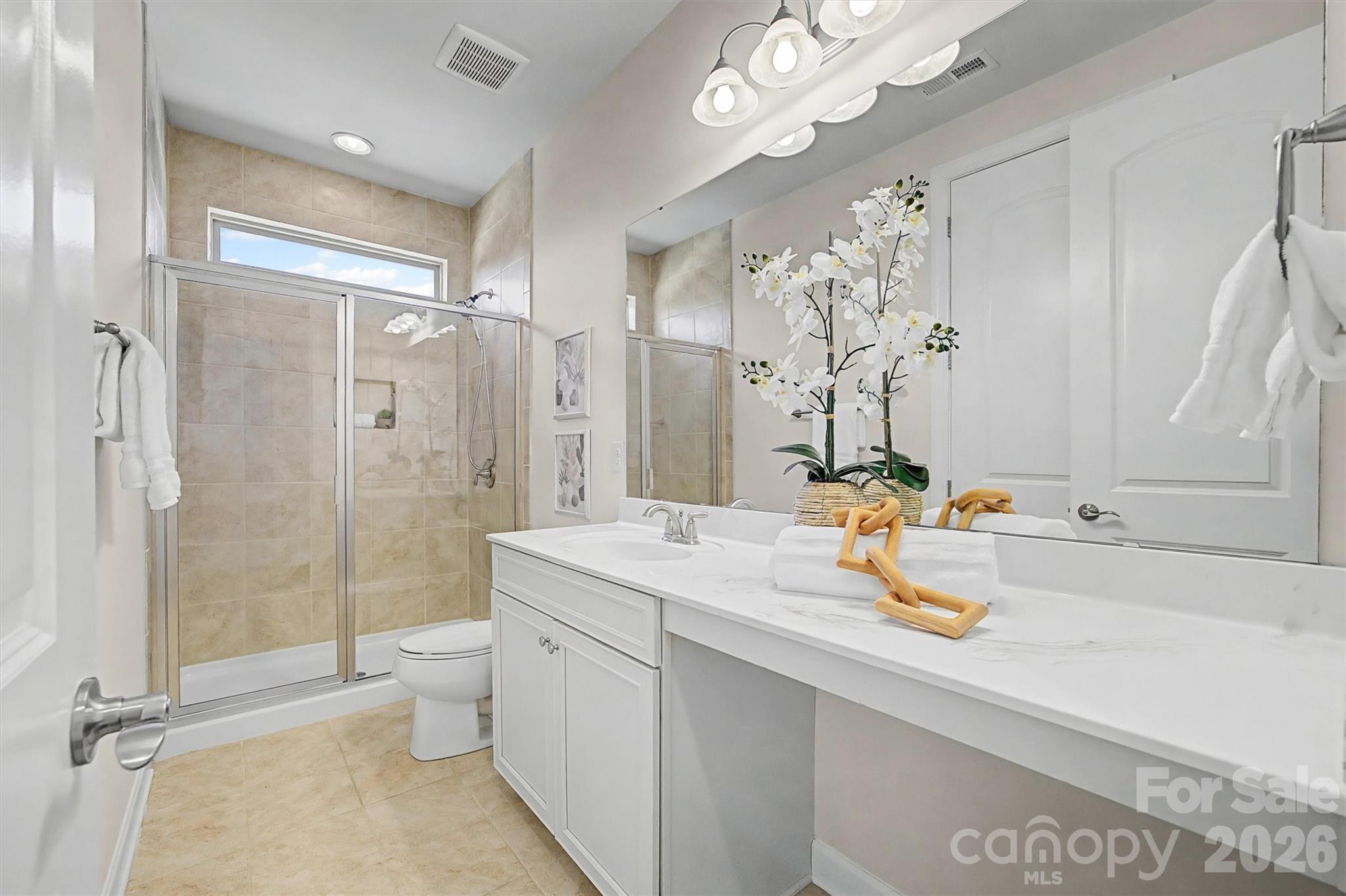 1268 Independence Street Tega Cay, SC 29708 - Photo 17 of 38 a bathroom with a sink a toilet and shower