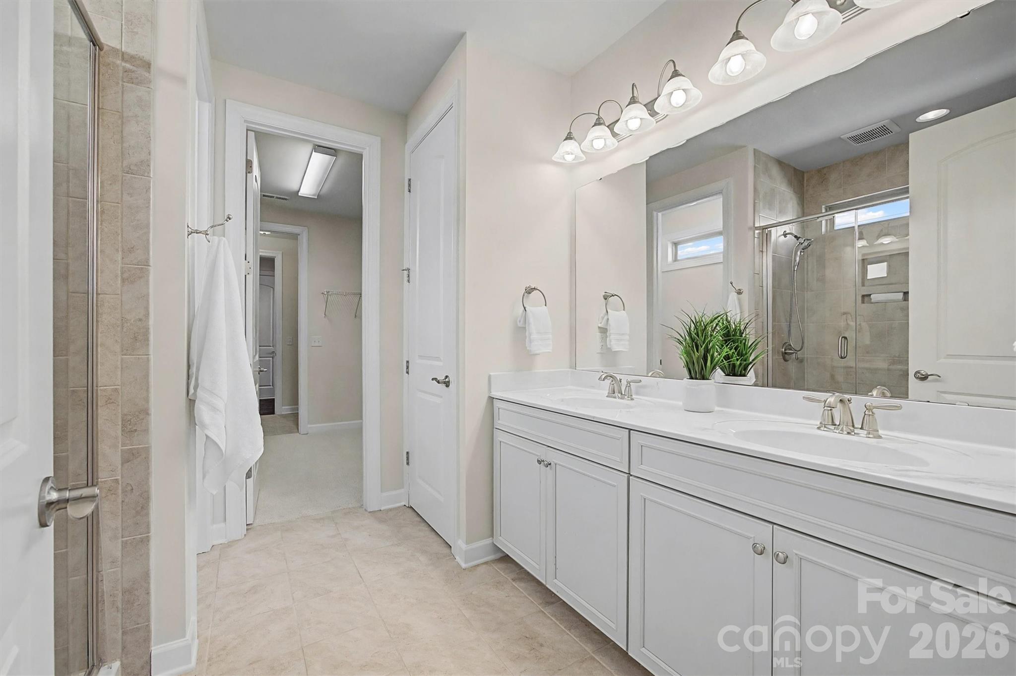 1268 Independence Street Tega Cay, SC 29708 - Photo 20 of 38 a spacious bathroom with a double vanity sink mirror and next to a window