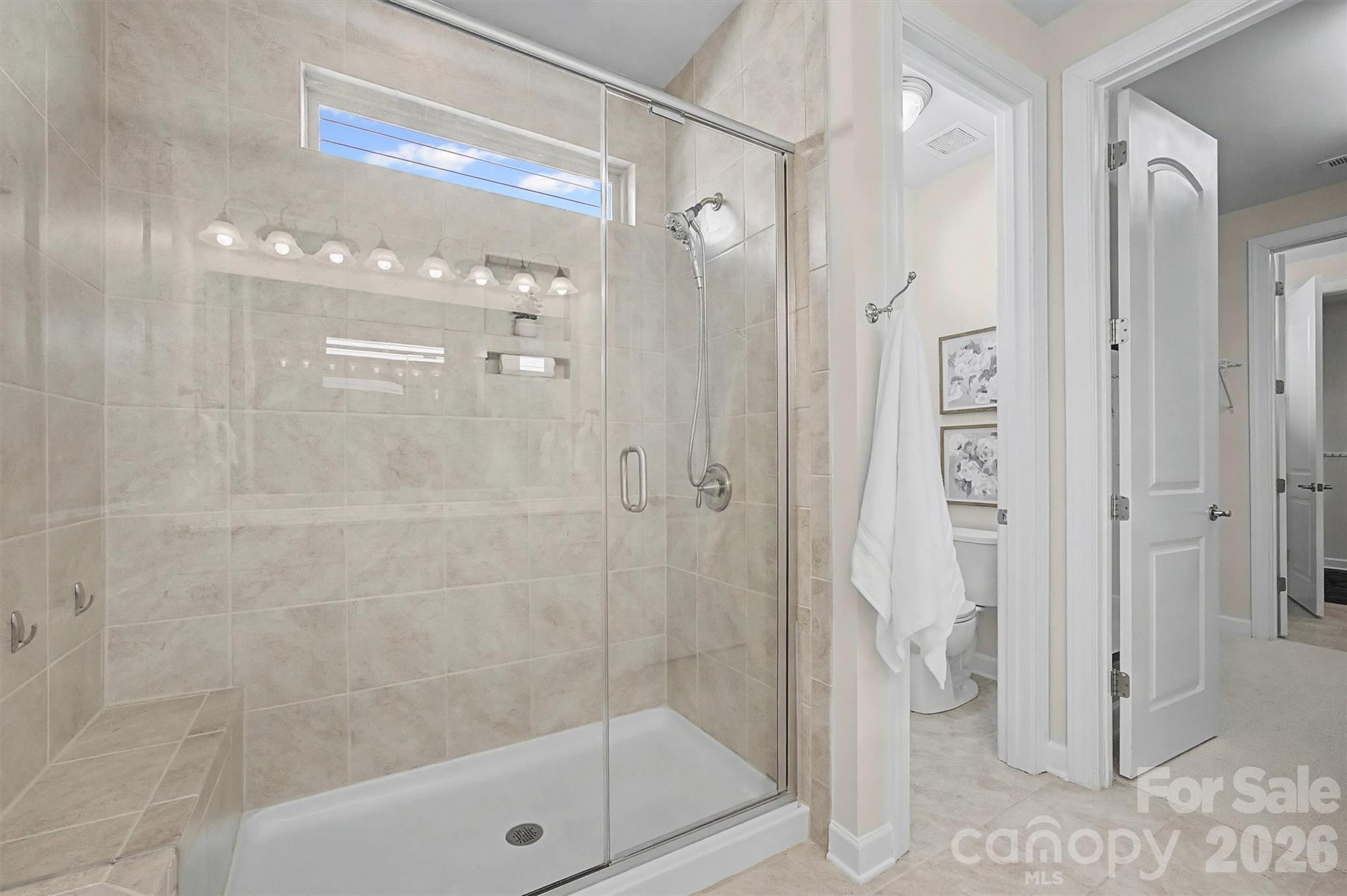 1268 Independence Street Tega Cay, SC 29708 - Photo 21 of 38 a bathroom with a glass shower door