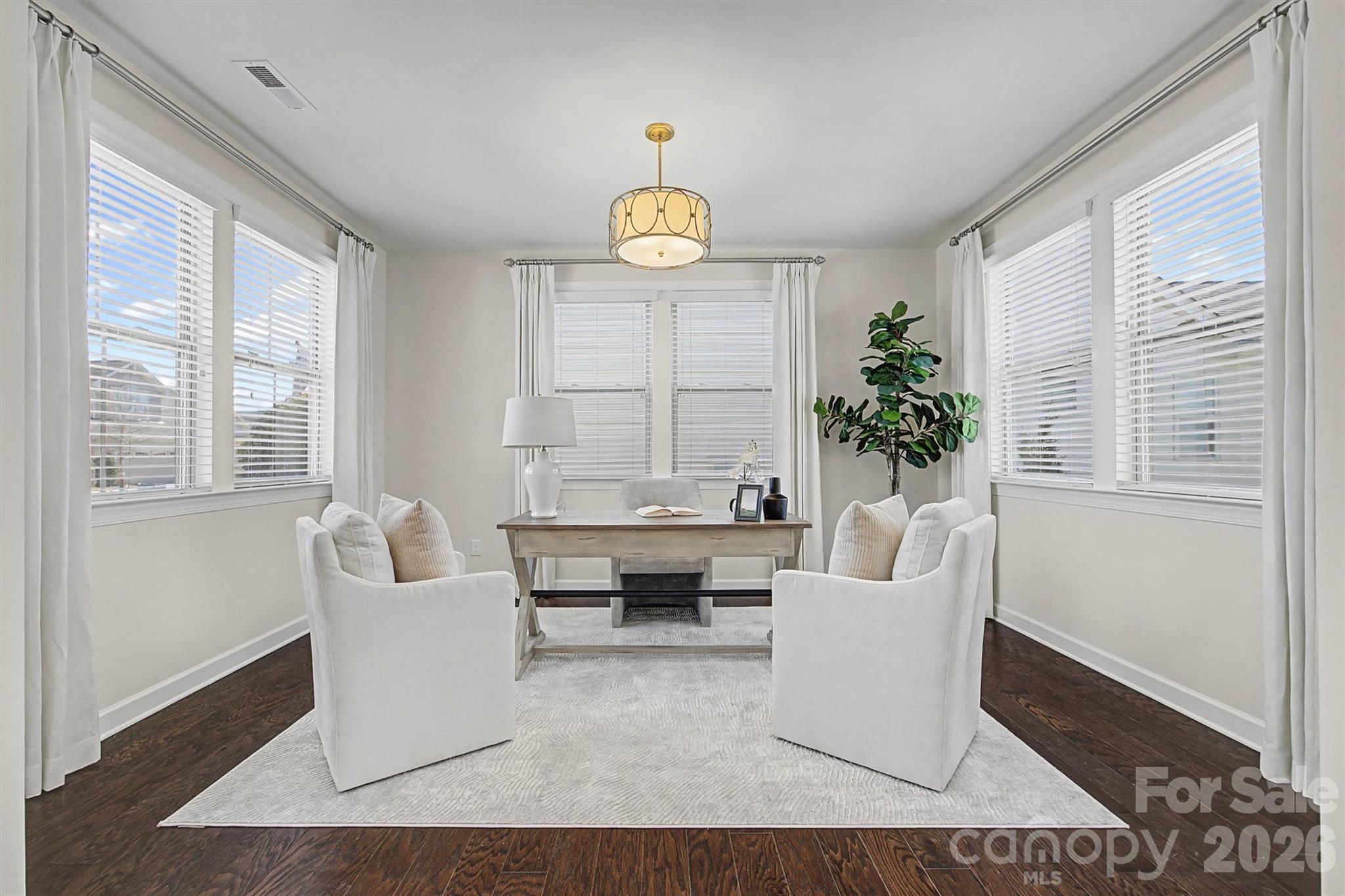 1268 Independence Street Tega Cay, SC 29708 - Photo 4 of 38 a living room with furniture a table and a potted plant