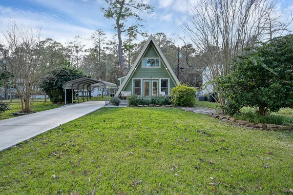 a front view of house with yard and green space