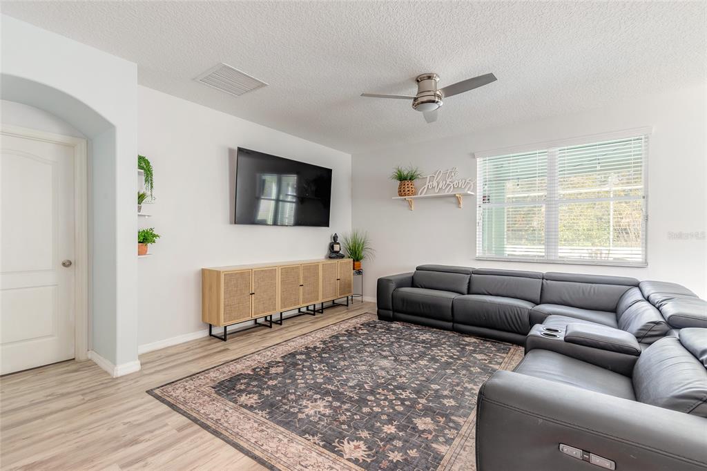 1215 Cap Diville Avenue Port Orange, FL 32129 - Photo 12 of 58 a living room with furniture and a rug