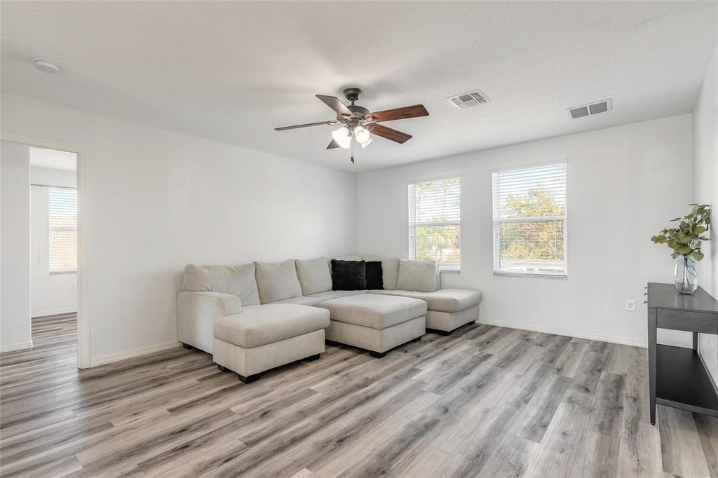 1215 Cap Diville Avenue Port Orange, FL 32129 - Photo 29 of 58 a living room with furniture and a large window