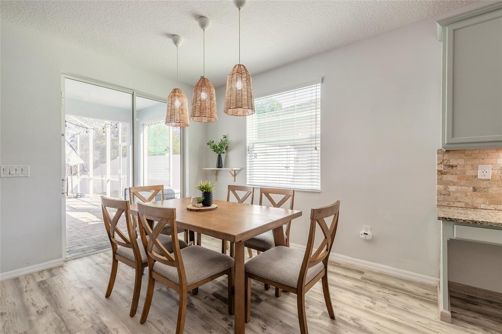 1215 Cap Diville Avenue Port Orange, FL 32129 - Photo 9 of 58 a dining room with furniture and window