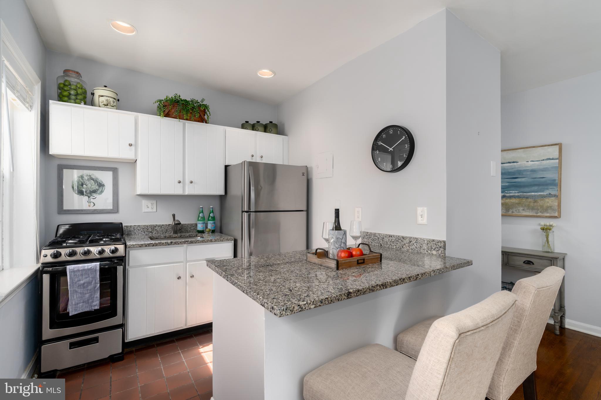 117 E Street Southeast, Unit 204 Washington, DC 20003 - Photo 9 of 22 Kitchen with Granite Countertops and Breakfast Bar