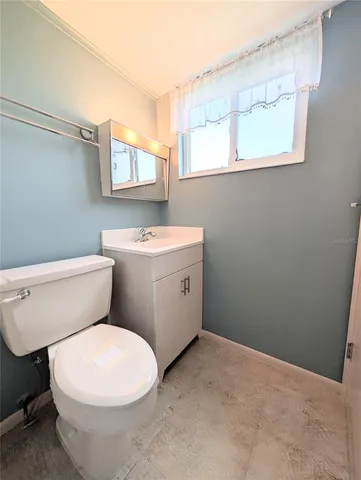 a white toilet sitting next to a bathroom sink