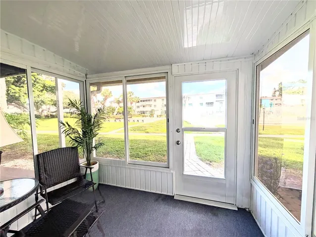 a view of a porch with furniture and garden