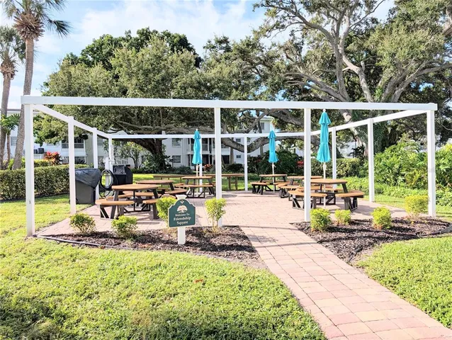 a front view of a house with a yard and potted plants