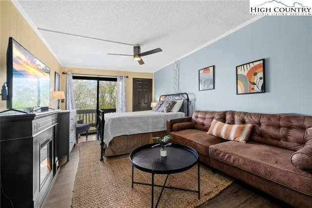a living room with furniture and a floor to ceiling window