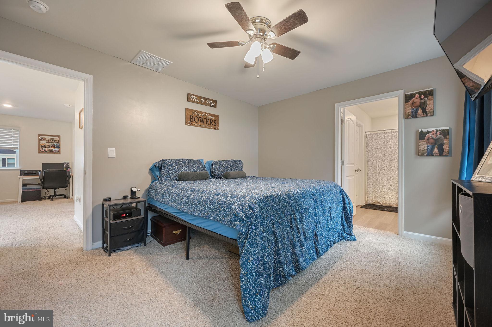 504 Currant Circle Magnolia, DE 19962 - Photo 13 of 27 a bedroom with a bed and a chandelier