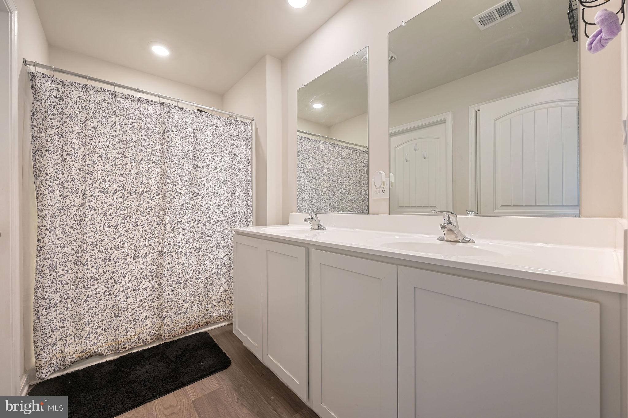 504 Currant Circle Magnolia, DE 19962 - Photo 15 of 27 a bathroom with double vanity sink a mirror and a shower
