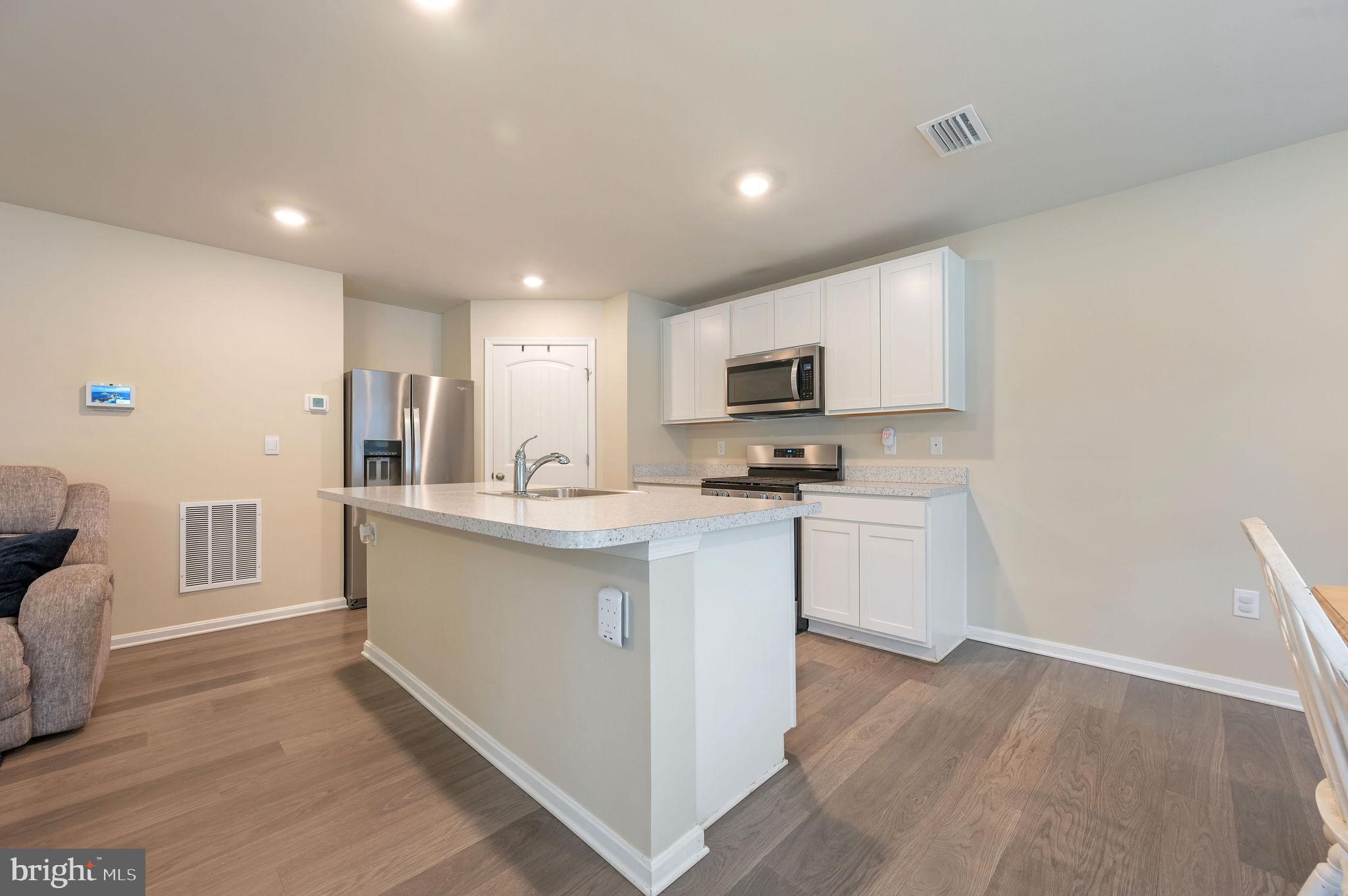 504 Currant Circle Magnolia, DE 19962 - Photo 6 of 27 a kitchen with white cabinets and appliances