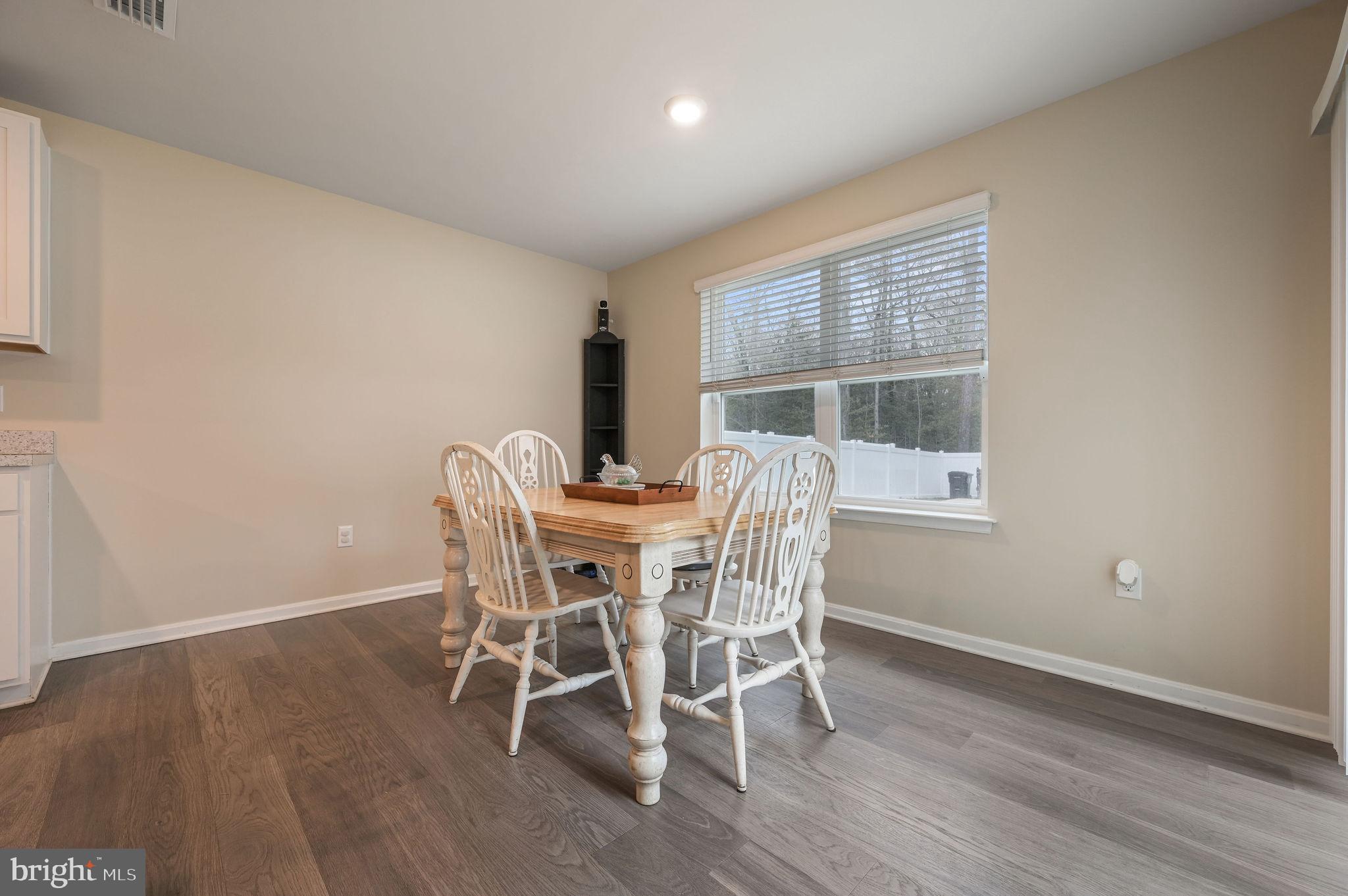 504 Currant Circle Magnolia, DE 19962 - Photo 7 of 27 a dining room with furniture and wooden floor