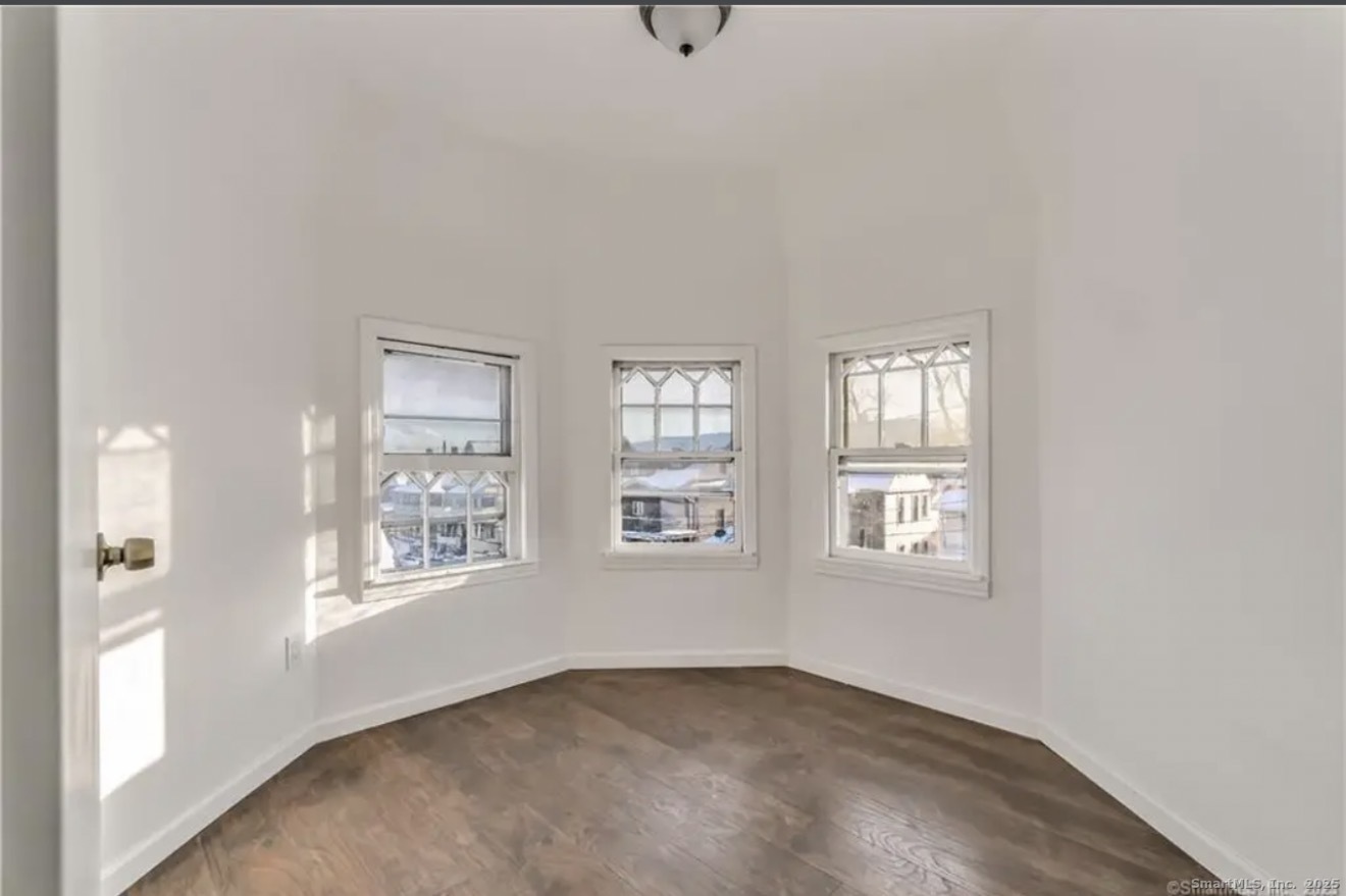 74 Carleton Avenue Bridgeport, CT 06604 - Photo 12 of 15 an empty room with windows