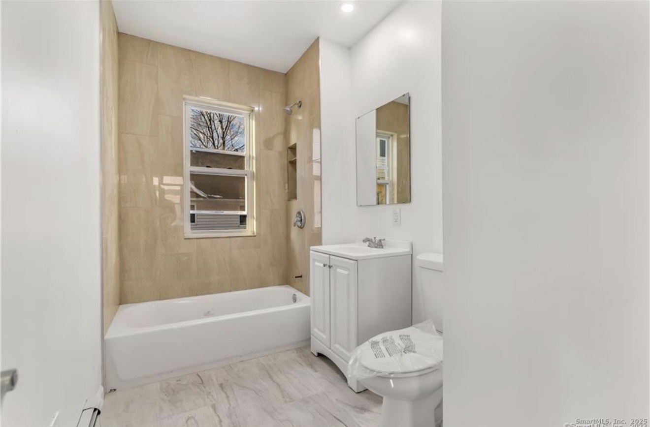 74 Carleton Avenue Bridgeport, CT 06604 - Photo 14 of 15 a bathroom with a toilet and a bathtub