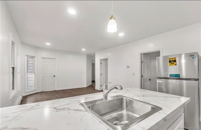 a kitchen with a sink and refrigerator