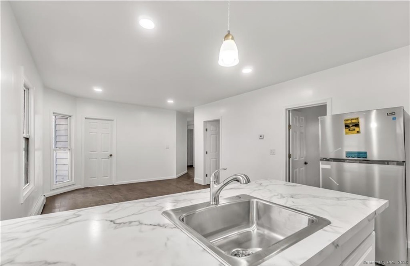 74 Carleton Avenue Bridgeport, CT 06604 - Photo 6 of 15 a kitchen with a sink and refrigerator