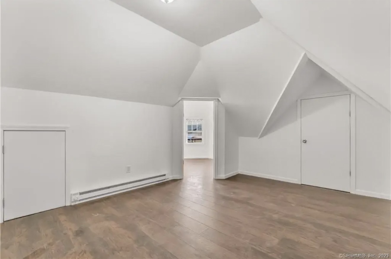 74 Carleton Avenue Bridgeport, CT 06604 - Photo 9 of 15 a view of an empty room with wooden floor