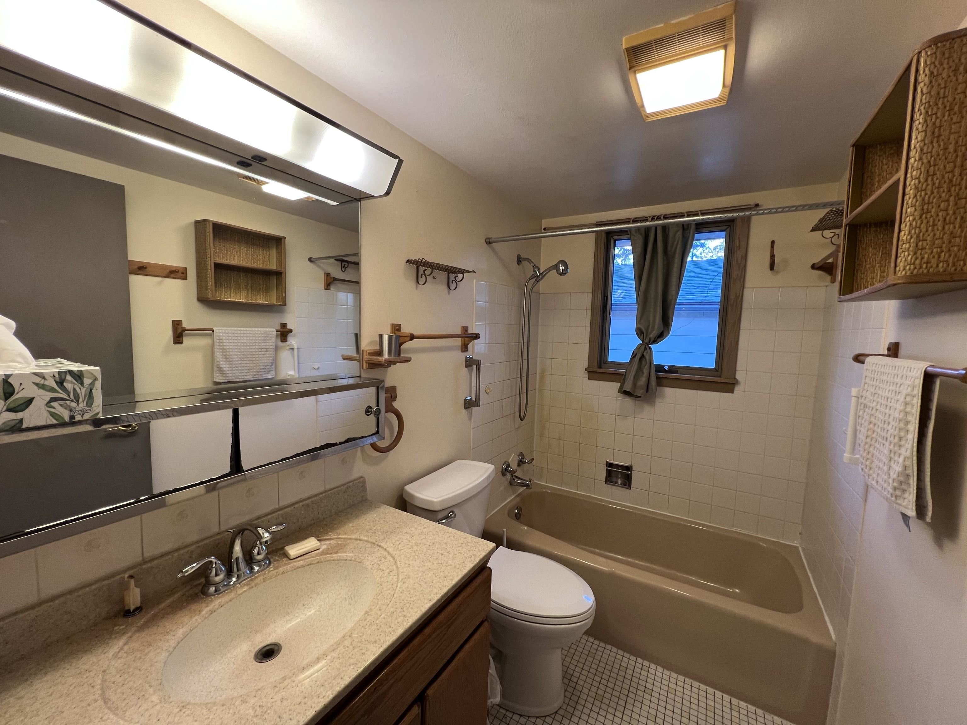 202 North 58th Street Superior, WI 54880 - Photo 16 of 30 Full bathroom featuring tub / shower combination, vanity, and tasteful backsplash