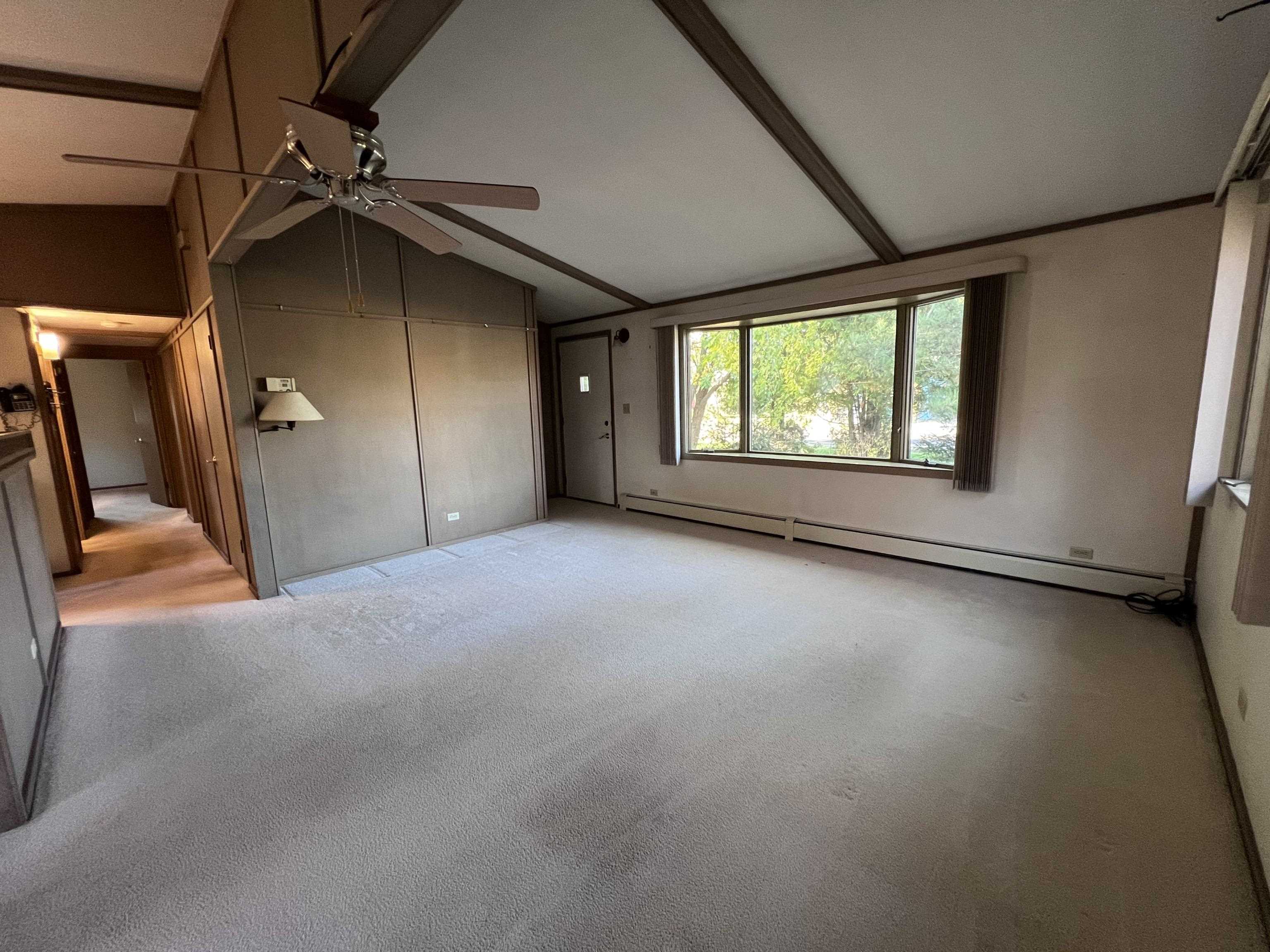 202 North 58th Street Superior, WI 54880 - Photo 7 of 30 Unfurnished living room with carpet flooring, baseboard heating, and ceiling fan