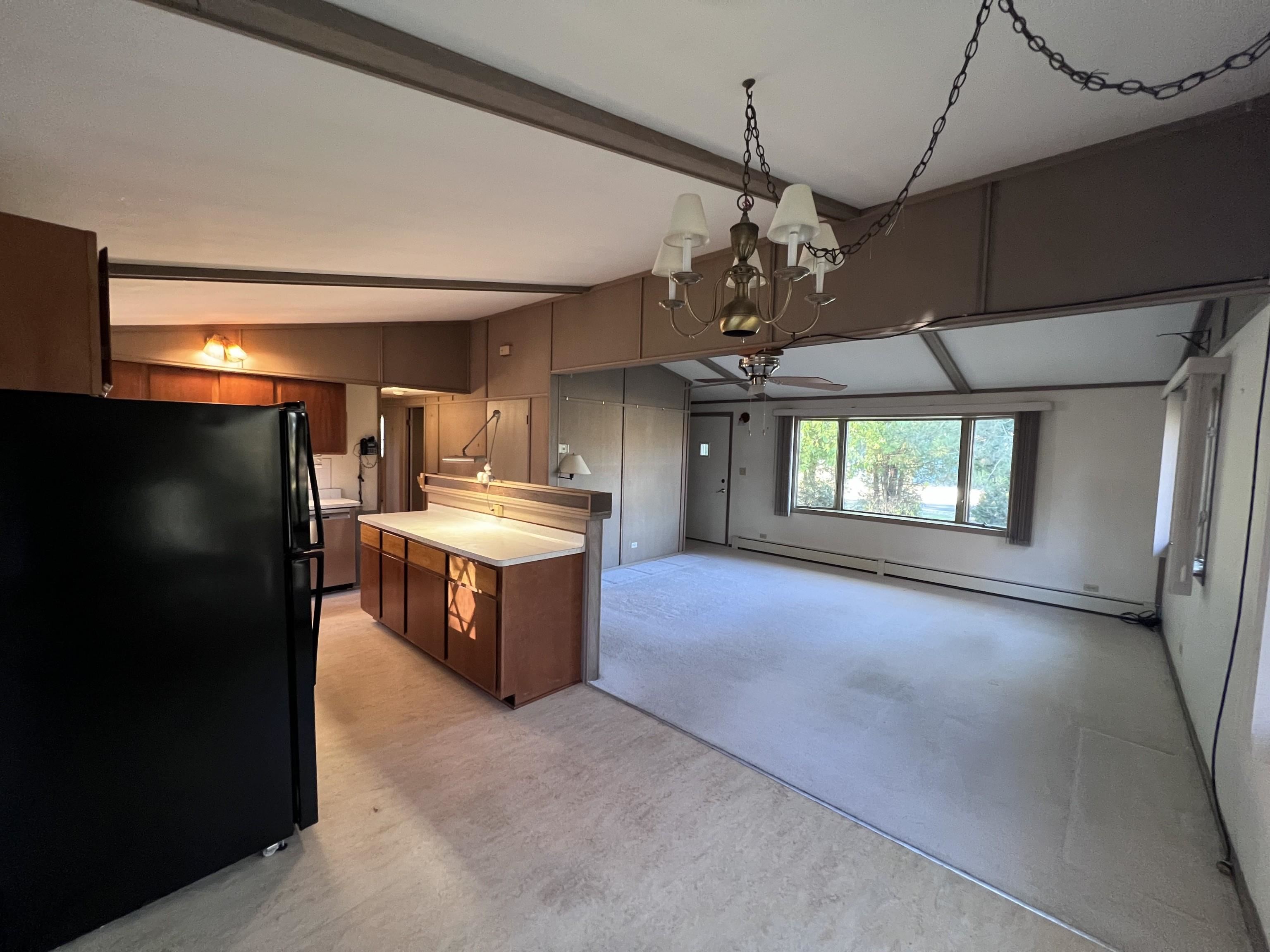 202 North 58th Street Superior, WI 54880 - Photo 30 of 30 Kitchen with freestanding refrigerator, open floor plan, light countertops, baseboard heating, and a chandelier
