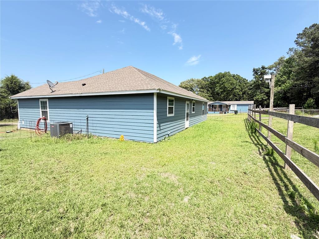 8261 County Road 381 Tyler, TX 75708 - Photo 8 of 40 a view of a house with a backyard