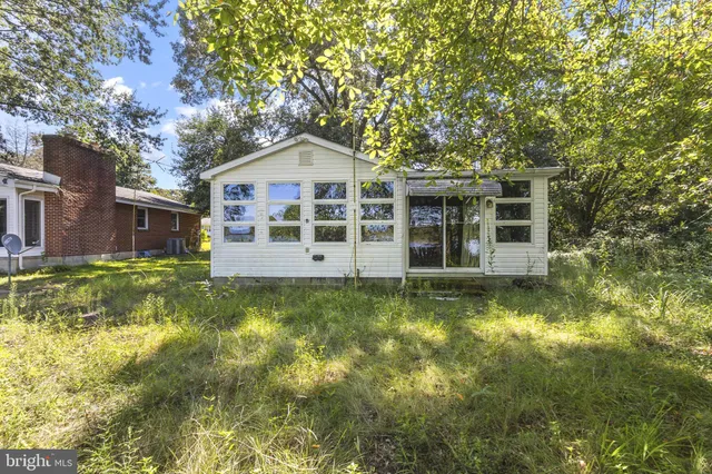 a view of a brick house with a large windows and large trees