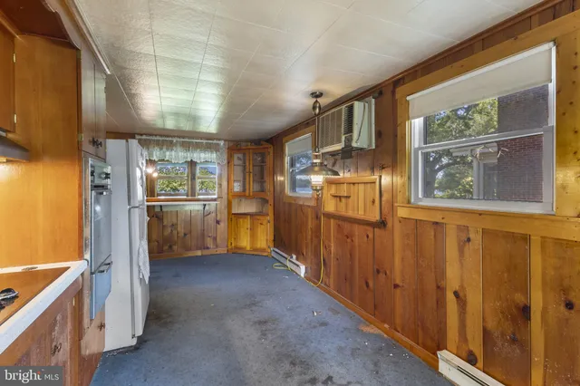 a view of a refrigerator in kitchen and wooden floor