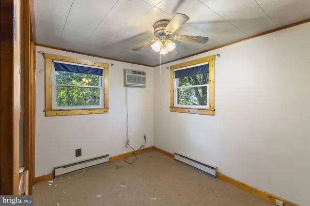 en empty room with window and ceiling fan