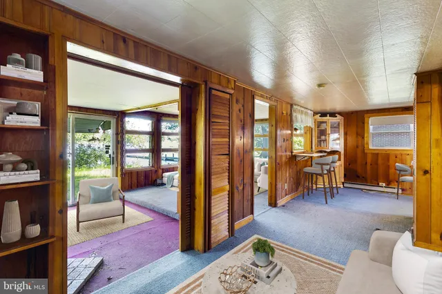 a living room with furniture and a floor to ceiling window
