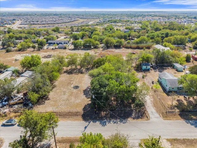 an aerial view of a houses with a yard