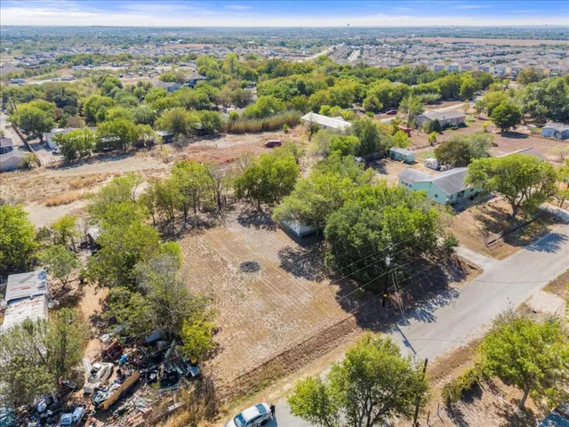 an aerial view of a houses with a yard