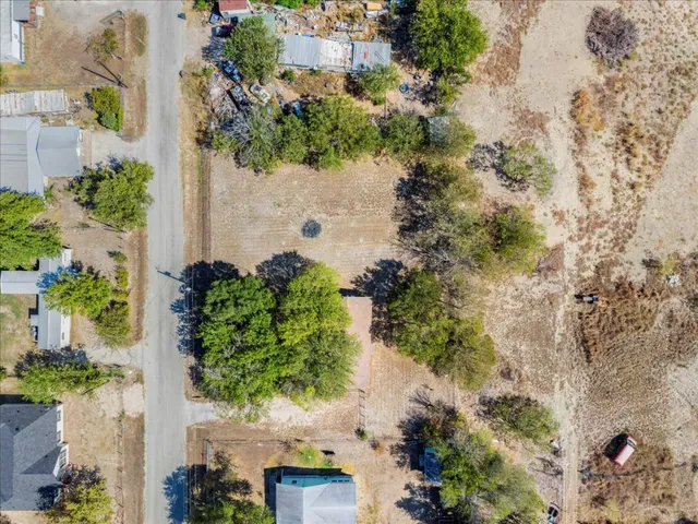 an aerial view of a house with a yard and garden