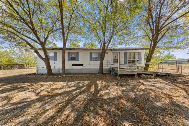a view of a house with a yard covered in snow