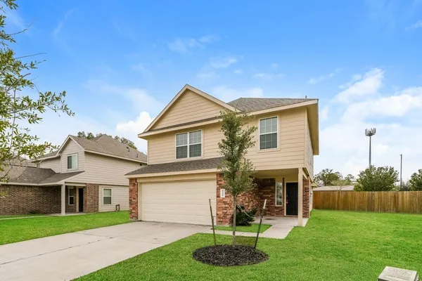 a front view of a house with a yard and garage