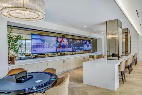 a living room with furniture a rug and a floor to ceiling window