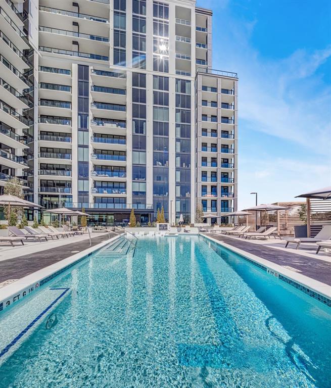 2425 Peachtree Street Northeast, Unit 1505 Atlanta, GA 30305 - Photo 22 of 25 a swimming pool with outdoor seating and yard